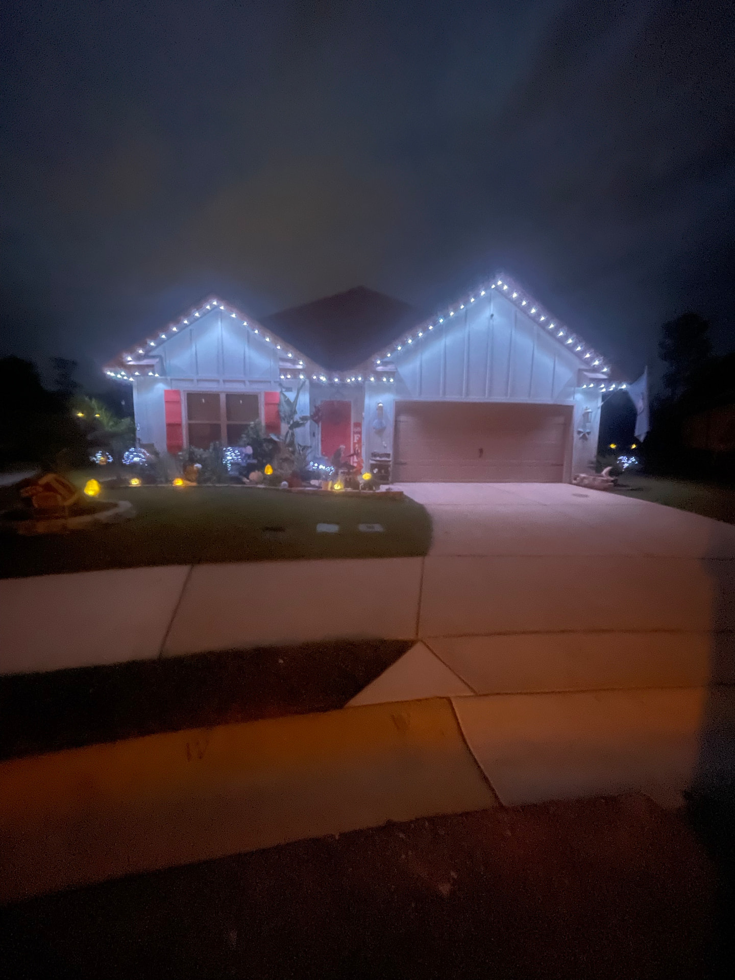 Beautiful home at dusk with elegant permanent holiday lighting along the roofline